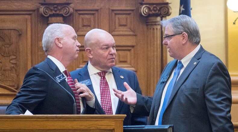 Senate Pro Tem Butch Miller, from left, Senate Majority Leader Mike Dugan and Senate Minority Leader Steve Henson discuss changes to the state Senate’s rules Monday during the first day of Georgia’s legislative session for 2019. (ALYSSA POINTER/ALYSSA.POINTER@AJC.COM)
