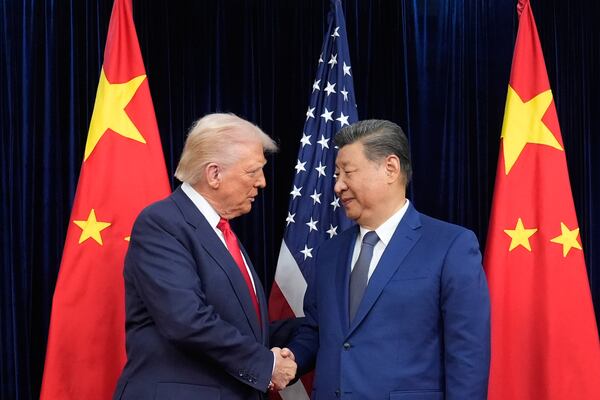 President Donald Trump, left, and Chinese President Xi Jinping, right, shake hands before their meeting at Gimhae International Airport in Busan, South Korea, Thursday, Oct. 30, 2025. (Mark Schiefelbein/AP)