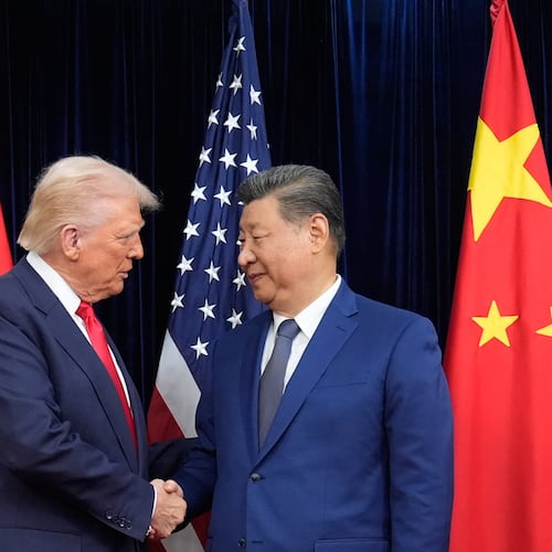 President Donald Trump, left, and Chinese President Xi Jinping, right, shake hands before their meeting at Gimhae International Airport in Busan, South Korea, Thursday, Oct. 30, 2025. (AP Photo/Mark Schiefelbein)