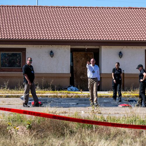 FILE - Fremont County coroner Randy Keller, center, and other authorities survey the area where they plan to put up tents at the Return to Nature Funeral Home where over 100 bodies have been improperly stored, Saturday, Oct. 7, 2023, in Penrose, Colo. (Parker Seibold/The Gazette via AP, File)/The Gazette via AP)