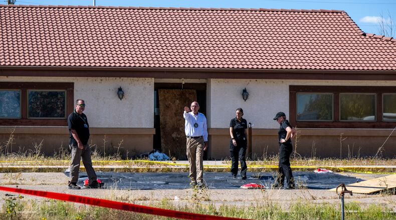 FILE - Fremont County coroner Randy Keller, center, and other authorities survey the area where they plan to put up tents at the Return to Nature Funeral Home where over 100 bodies have been improperly stored, Saturday, Oct. 7, 2023, in Penrose, Colo. (Parker Seibold/The Gazette via AP, File)/The Gazette via AP)