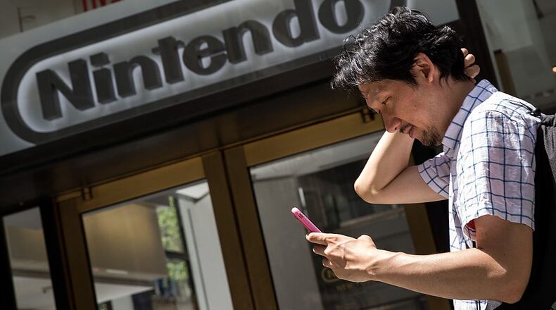 NEW YORK, NY - JULY 11: A man plays Pokemon Go on his smartphone outside of Nintendo's flagship store, July 11, 2016 in New York City. The success of Nintendo's new smartphone game, Pokemon Go, has sent shares of Nintendo soaring. (Photo by Drew Angerer/Getty Images)