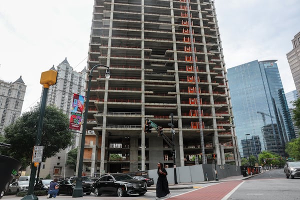 The Campanile building is visible from Peachtree Street NE and 14th Street in Atlanta on May 22, 2026. The building has remained incomplete for years and locals are unhappy with the slow progress. (Arvin Temkar/AJC)