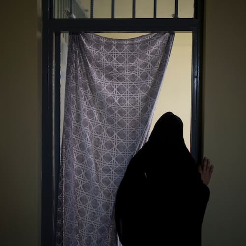 FILE - An Afghan woman walks out of a cell inside the women's section of the Pul-e-Charkhi prison in Kabul, Afghanistan, on Sept. 23, 2021. (AP Photo/Felipe Dana, File)