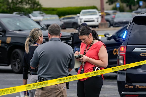 Officials respond to an officer-involved shooting investigation in the parking lot of the Town Center at Cobb mall on Wednesday, May 27, 2026. (Ben Hendren for the AJC)