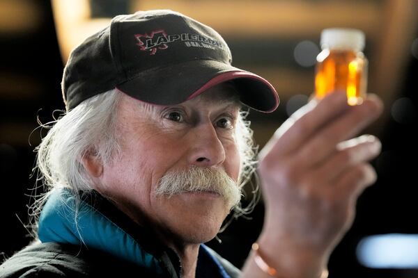 Maple syrup producer Jim Judd looks a sample of maple syrup at Judd's Wayeeses Farms in Morgan, Vt., on Friday, April 11, 2025. (AP Photo/Robert F. Bukaty)