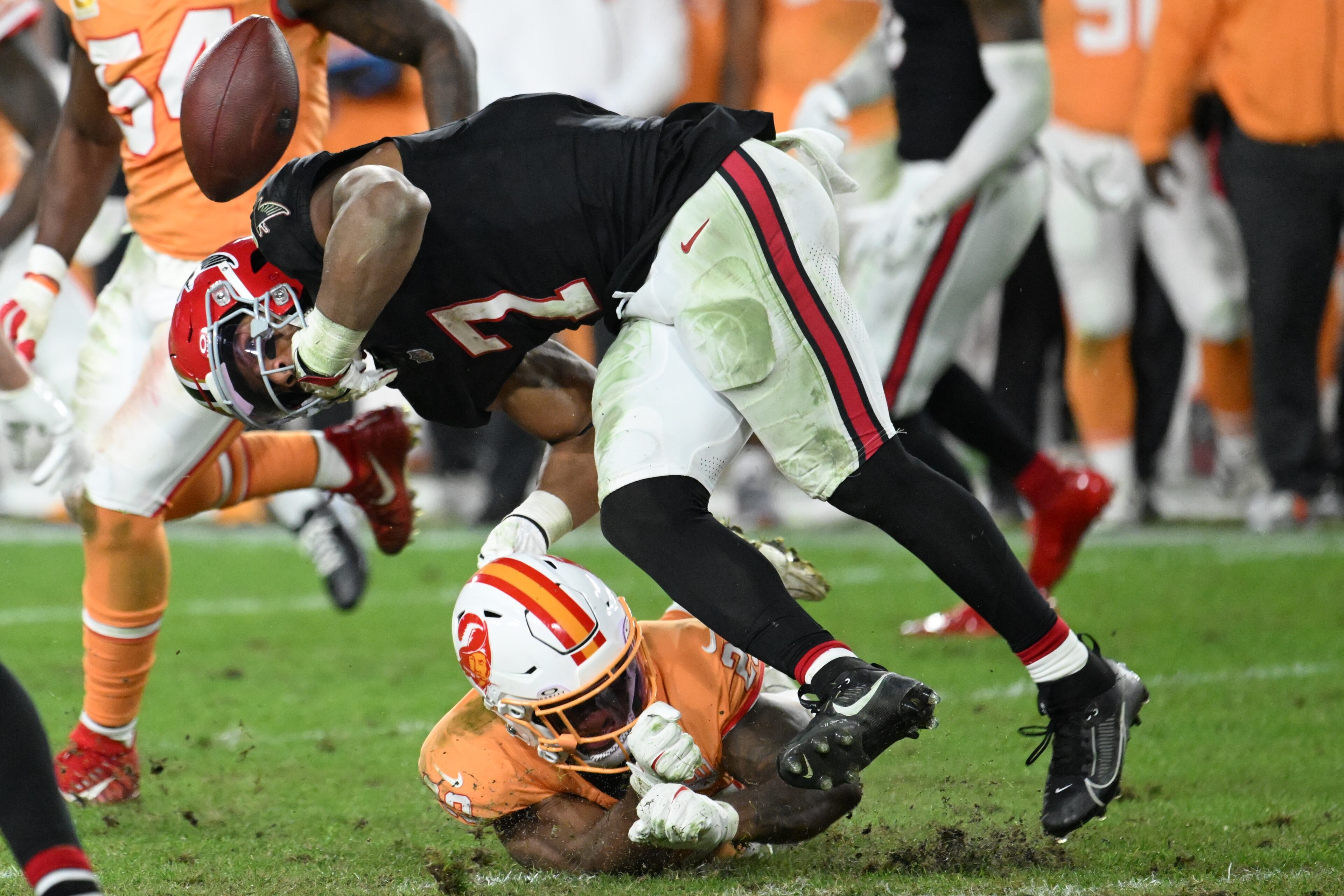 Tampa Bay Buccaneers safety Christian Izien (29) causes a fumble against Atlanta Falcons running back Bijan Robinson (7) during the second half of an NFL football game, Thursday, Dec. 11, 2025, in Tampa, Fla. (AP Photo/Jason Behnken)