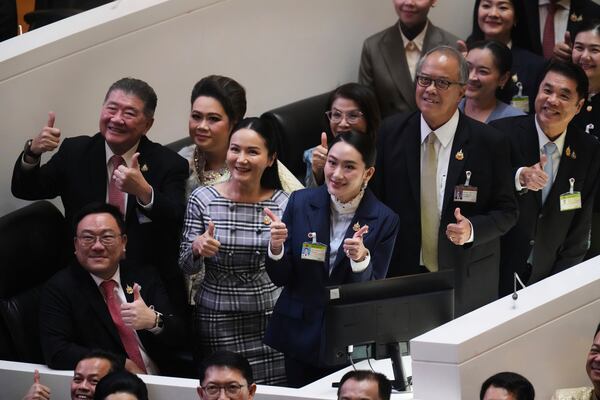 Thailand Prime Minister Paetongtarn Shinawatra, center, reacts after a no-confidence vote against her was defeated in Bangkok, Thailand, Wednesday, March 26, 2025. (AP Photo/Sakchai Lalit)