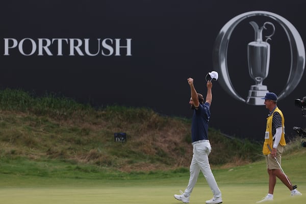 Scottie Scheffler of the United States, celebrates winning the British Open golf championship at the Royal Portrush Golf Club, Northern Ireland, Sunday, July 20, 2025. (AP Photo/Peter Morrison)