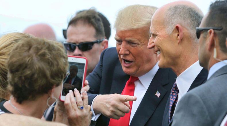 Accompanied by Florida governor Rick Scott, who is also running for the U.S. Senate, President Trump is welcomed at Orlando International Airport, Monday, Oct. 8, 2018. Trump delivered remarks at the International Association of Chiefs of Police, at the Orange County Convention Center, in Orlando, Fla.