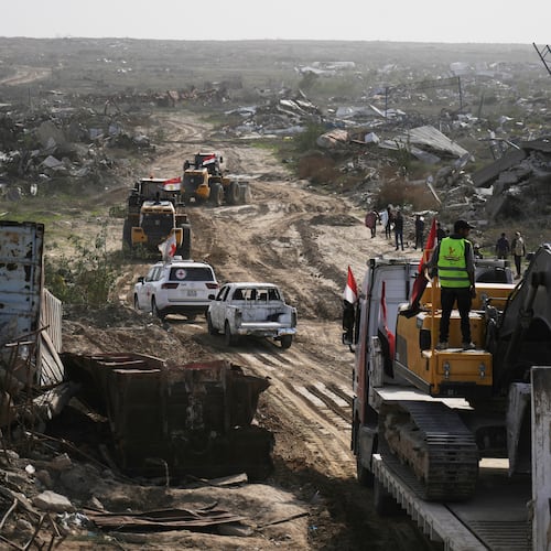 FILE - Hamas militants and Egyptian workers accompanied by members of the International Committee of the Red Cross (ICRC) head to Zeitoun neighborhood of Gaza City to search for the remains of deceased hostages, Dec. 8, 2025. (AP Photo/Jehad Alshrafi, File)