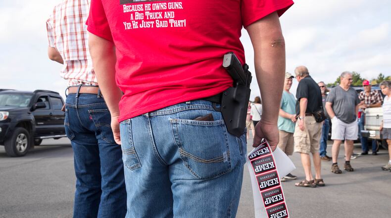 10/01/2018 -- Jasper, Georgia -- An Appalachian Gun, Pawn & Range employee hands out Brain Kemp campaign stickers during a campaign stop in Jasper, Monday, October 1, 2018. Monday was the first day of Brian Kemp's weeklong bus tour where he and his campaign will visit 27 counties in 5 days. (ALYSSA POINTER/ALYSSA.POINTER@AJC.COM)