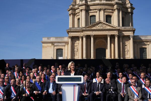 French far-right leader Marine Le Pen delivers her speech during the French far-right party national rally near the parliament in Paris, Sunday, April 6, 2025. (AP Photo/Michel Euler)