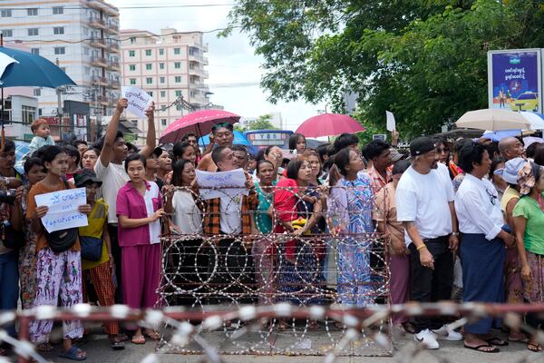 Family members and colleagues wait to welcome released prisoners outside the main gate of Insein prison as the head of Myanmar’s military government granted amnesty to thousands of prisoners to mark the country's traditional New Year Thursday, April 17, 2025, in Yangon, Myanmar. (AP Photo/Thein Zaw)