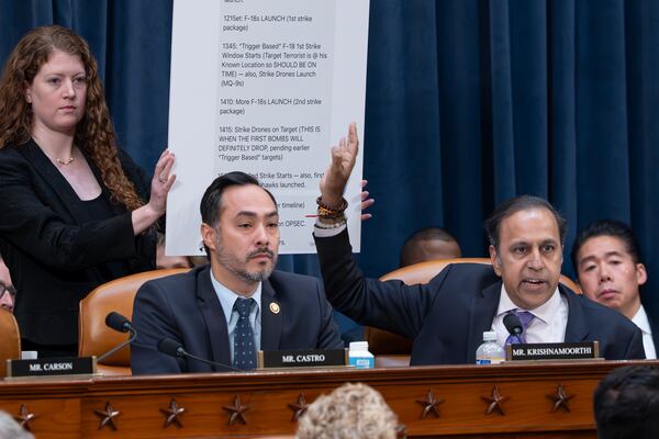 Rep. Raja Krishnamoorthi, D-Ill., right, joined by Rep. Joaquin Castro, D-Texas, left, points to a chart displaying a text message by Defense Secretary Pete Hegseth in a group chat that revealed U.S. military plans in Yemen to a journalist, as the House Intelligence Committee holds a hearing on worldwide threats, at the Capitol, in Washington, Wednesday, March 26, 2025. (AP Photo/J. Scott Applewhite)