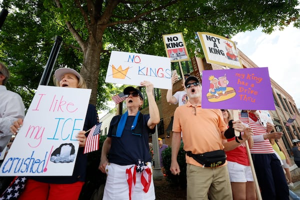 Demonstrators rallied in downtown Woodstock on Saturday as part of the nationwide "No Kings" protests against Trump administration policies.