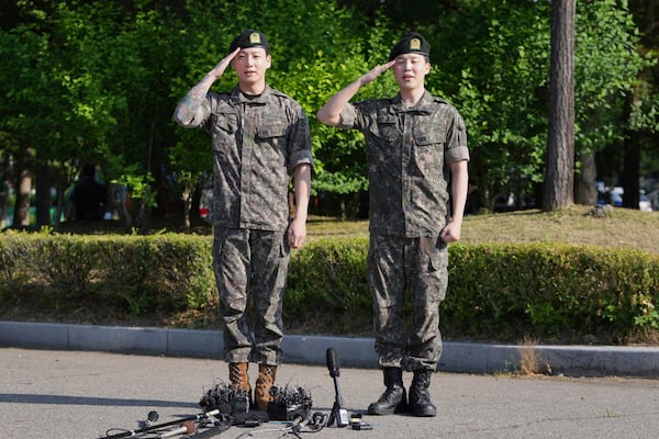 FILE - K-pop band BTS members Jimin, right, and Jung Kook salute after being discharged from a mandatory military service in Yeoncheon, South Korea, Wednesday, June 11, 2025. (AP Photo/Lee Jin-man, File)