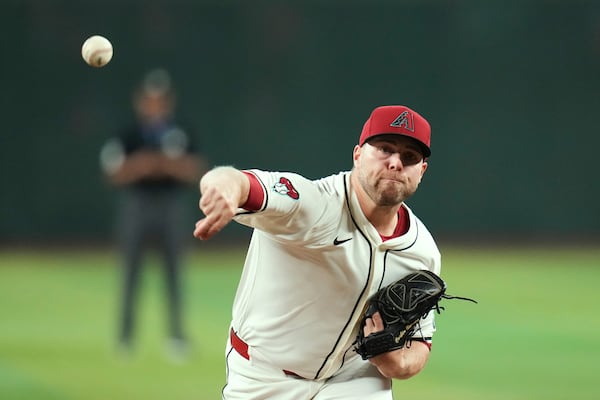 Arizona Diamondbacks starting pitcher Corbin Burnes warms up prior to a baseball game against the Pittsburgh Pirates Tuesday, May 27, 2025, in Phoenix. (AP Photo/Ross D. Franklin)