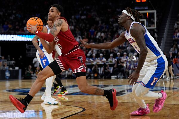 Texas Tech guard Chance McMillian, left, drives past Florida guard Denzel Aberdeen during the second half in the Elite Eight of the NCAA college basketball tournament, Saturday, March 29, 2025, in San Francisco. (AP Photo/Godofredo A. Vásquez)