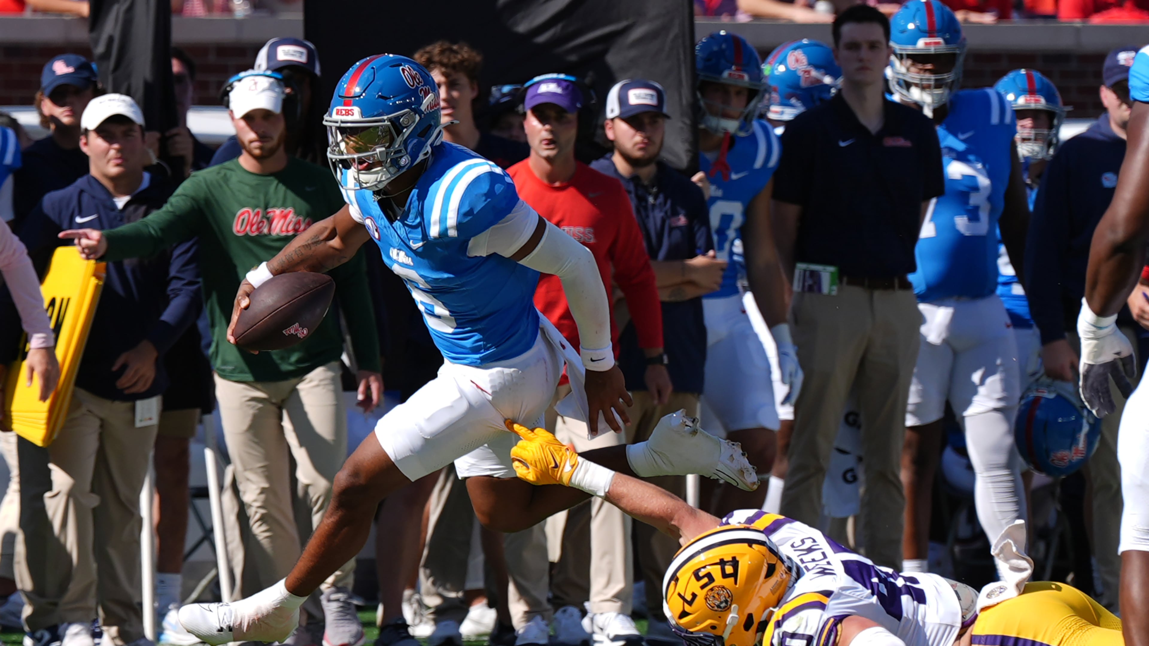 Mississippi quarterback Trinidad Chambliss (6) evades a tackle attempt by LSU linebacker Whit Weeks (40) during the first half of an NCAA college football game in Oxford, Miss., Saturday, Sept. 27, 2025. (AP Photo/Rogelio V. Solis)