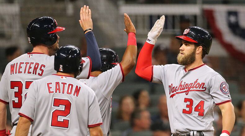 April 19, 2017, Atlanta: Washington Nationals Bryce Harper gets high fives at home hitting a grand slam off Atlanta Braves pitcher Julio Jones during the second inning for a 6-2 lead in a MLB baseball game on Wednesday, April 19, 2017, in Atlanta. It was back to back homers for Harper who had a solo homer in the first inning. Curtis Compton/ccompton@ajc.com