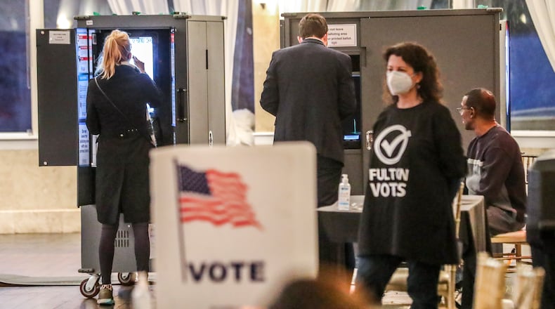 Voters cast ballots at Park Tavern, located at 500 10th St N.E. in Atlanta, on Nov. 30 during the city's mayoral runoff. (John Spink / John.Spink@ajc.com)
