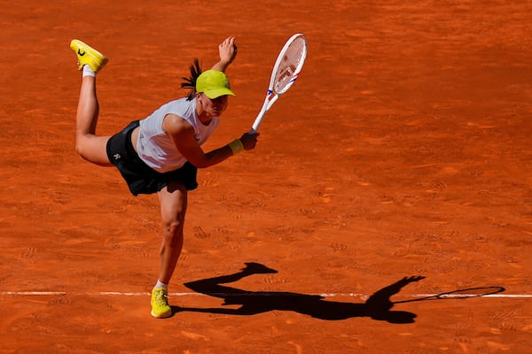 Poland's Iga Swiatek serves against Alexandra Eala of Philippines during the Madrid Open tennis tournament in Madrid, Spain, Thursday, April 24, 2025. (AP Photo/Manu Fernandez)