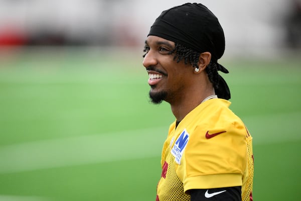 Washington Commanders quarterback Jayden Daniels looks on during an NFL football practice, Wednesday, May 28, 2025, in Ashburn, Va. (AP Photo/Nick Wass)