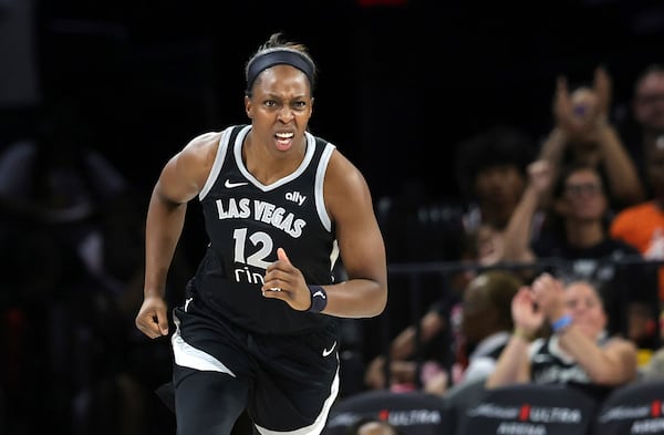 Las Vegas Aces guard Chelsea Gray (12) reacts after scoring a basket against the Phoenix Mercury during the first half of an WNBA basketball game Sunday, June 15, 2025, in Las Vegas. (Steve Marcus/Las Vegas Sun via AP)