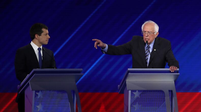 HOUSTON, TEXAS - SEPTEMBER 12: Democratic presidential candidates South Bend, Indiana Mayor Pete Buttigieg and Sen. Bernie Sanders (I-VT) interact during the Democratic Presidential Debate at Texas Southern University's Health and PE Center on September 12, 2019 in Houston, Texas. Ten Democratic presidential hopefuls were chosen from the larger field of candidates to participate in the debate hosted by ABC News in partnership with Univision. (Photo by Win McNamee/Getty Images)
