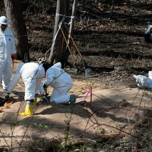 FILE - Workers prepare to take soil samples where raw sewage flowed near the Potomac River in Cabin John, Md., March 14, 2026. (AP Photo/Cliff Owen, File)