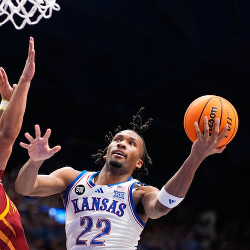 Kansas guard Darryn Peterson (22) shoots over Iowa State forward Joshua Jefferson (5) during the first half of an NCAA college basketball game Tuesday, Jan. 13, 2026, in Lawrence, Kan. (AP Photo/Charlie Riedel)