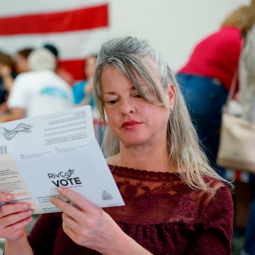 Tiffany Valencia, a Riverside County resident, fills out a primary election ballot during a "Barbeque, Beer and Ballots" event organized by Reform California on Saturday, May 9, 2026, in Corona, Calif. (AP Photo/Caroline Brehman)