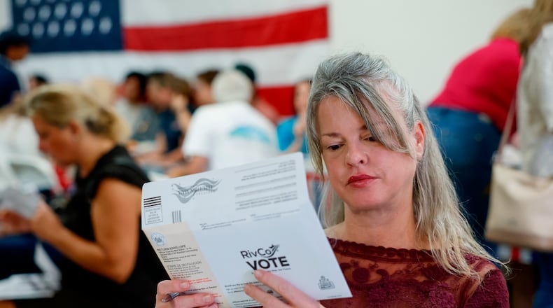 Tiffany Valencia, a Riverside County resident, fills out a primary election ballot during a "Barbeque, Beer and Ballots" event organized by Reform California on Saturday, May 9, 2026, in Corona, Calif. (AP Photo/Caroline Brehman)