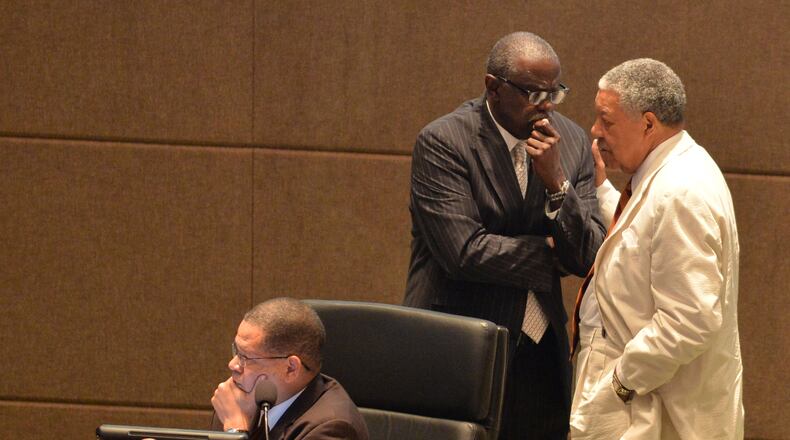 Fulton County Board of Commissioners Bill Edwards and Robb Pitts confer during a meeting in August. The county commission, controlled by Democrats, has been fighting with Republicans in the Legislature over county operations. BRANT SANDERLIN /BSANDERLIN@AJC.COM .