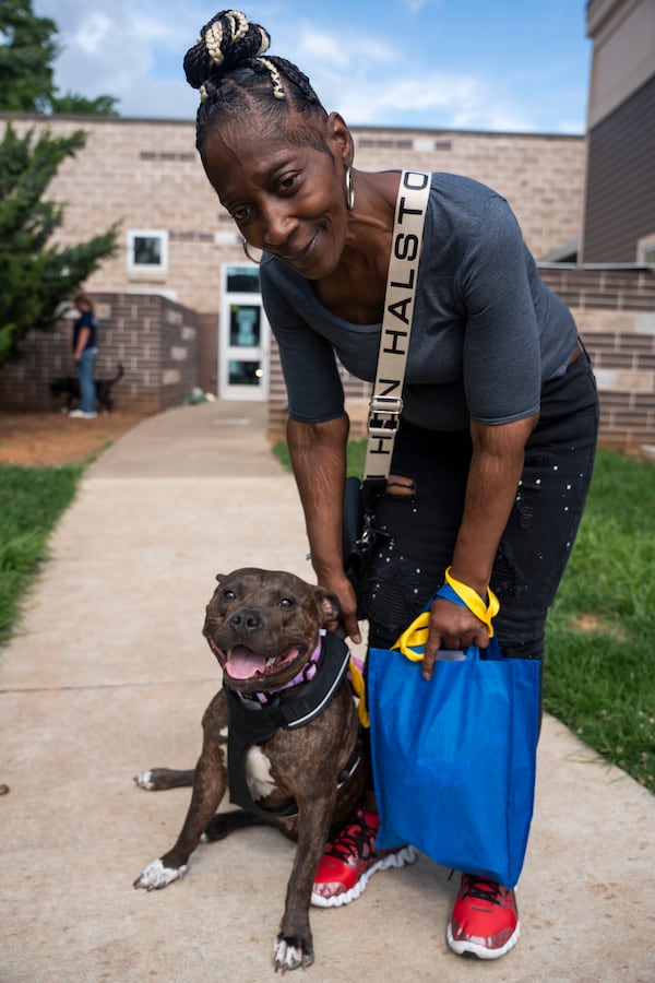 Coretta Johnson reclaims her recently adopted dog, Tori. (Olivia Bowdoin for the AJC)