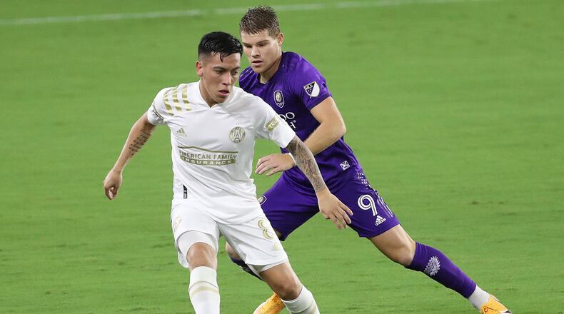 Atlanta United's Ezequiel Barco (8) and Orlando City's Chris Mueller battle for the ball at Exploria Stadium in Orlando, Florida, on Wednesday, Oct. 28, 2020. (Stephen M. Dowell/Orlando Sentinel/TNS)
