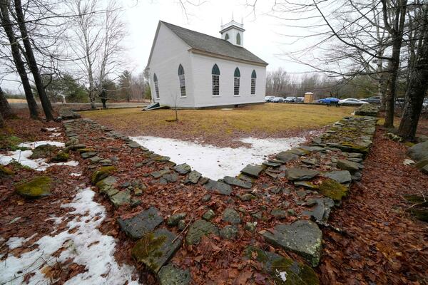 A rock wall surrounds the South Solon Meeting House, Sunday, April 6, 2025, in Solon, Maine. (AP Photo/Robert F. Bukaty)