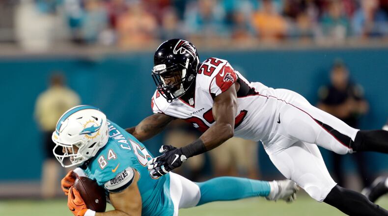 Miami Dolphins tight end Jordan Cameron (84) is brought down by Atlanta Falcons strong safety Keanu Neal (22) after a reception during the first half of an NFL preseason football game in Orlando, Fla., Thursday, Aug. 25, 2016.(AP Photo/Willie J. Allen Jr.)