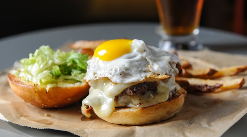 The Comet Burger has two 3-ounce patties, bacon, cheddar, a fried egg, beer dijonnaise and mixed greens. (BECKY STEIN PHOTOGRAPHY)