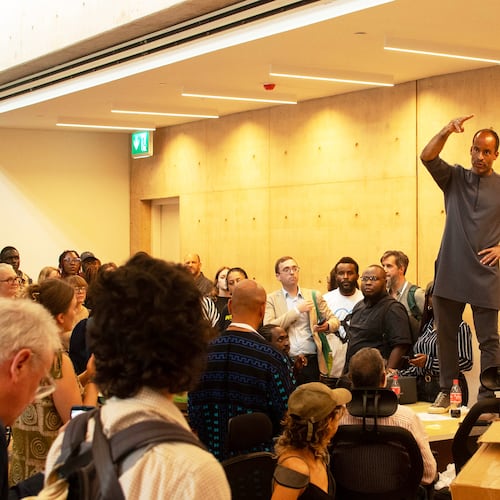 A man speaks to guests to calm down during the soft launch of the new, state backed, Museum of West African Arts, that was disrupted by protesters in Benin City, Nigeria, Sunday, Nov. 9, 2025. (AP Photo/Akpobasaha Oghenemaro Godspower )