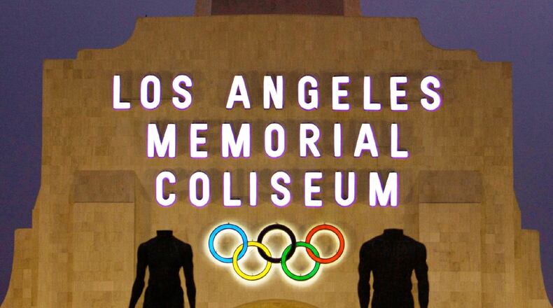 FILE - This Feb. 13, 2008, file photo shows the facade of The Los Angeles Memorial Coliseum in Los Angeles. The Los Angeles bid committee for the 2024 Olympics is projecting a $5.3 billion budget, a number that would be less than half the cost of the recently completed Rio de Janeiro Games and about a quarter of where Tokyo’s ballooning budget for 2020 currently stands. Bid officials say they can do this because more than 30 venues already exist and those that don’t will be built as temporary structures. (AP Photo/Damian Dovarganes, File)