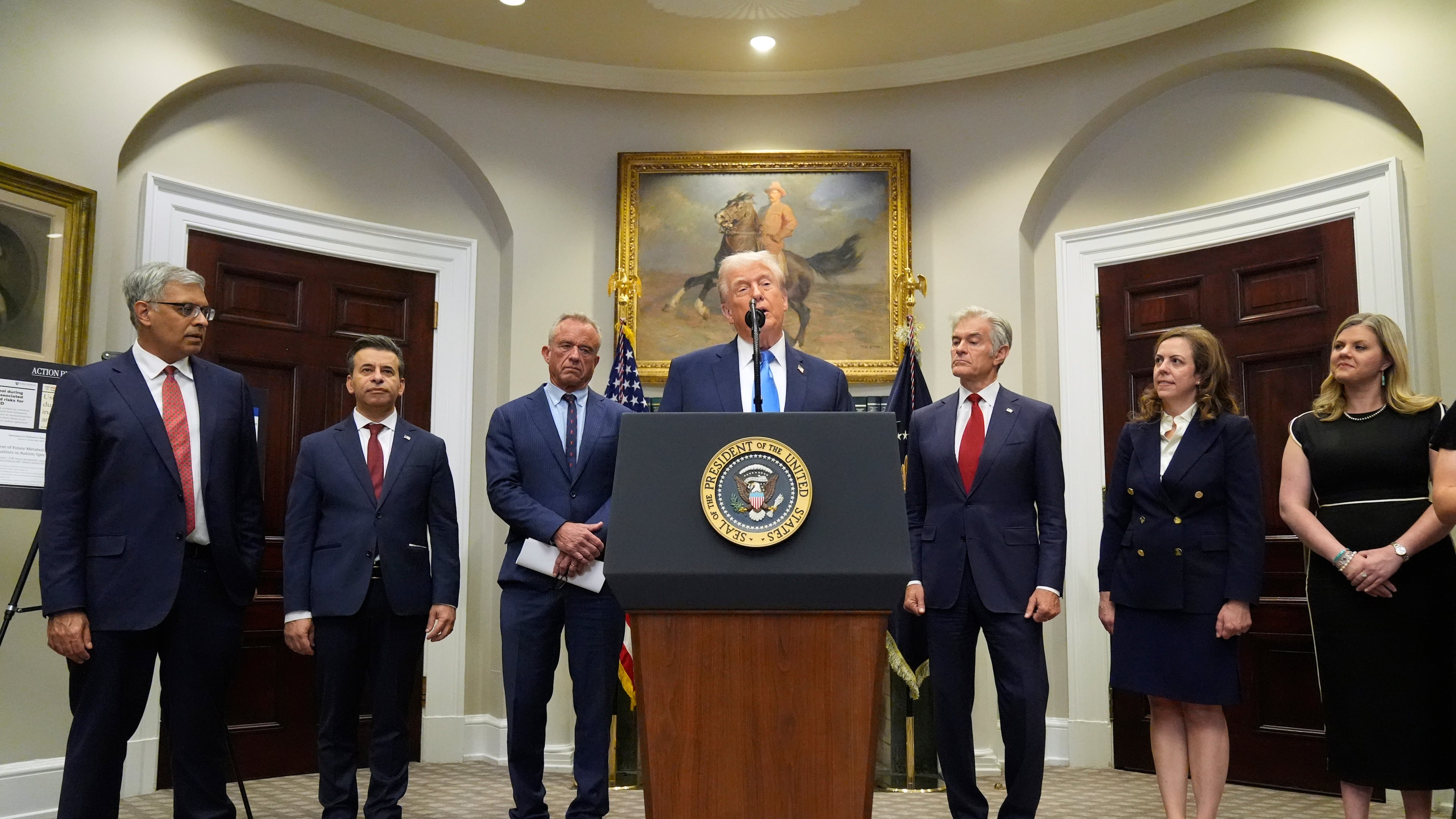 President Donald Trump speaks in the Roosevelt Room of the White House, Monday, Sept. 22, 2025, in Washington, as from left, Dr. Jay Bhattacharya, director of the National Institutes of Health, Dr. Marty Makary, commissioner of the Food and Drug Administration, Health and Human Services Secretary Robert F. Kennedy Jr., Centers for Medicare & Medicaid Services administrator Dr. Mehmet Oz, Dr. Dorothy Fink, acting assistant secretary for health, and Jackie O'Brien, listen. (AP Photo/Mark Schiefelbein)