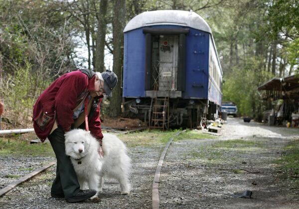 Dante and Anya, his Siberian Huskey, stand outside The Survivor on a side track he leases from the railroad. Years ago, he would hook the car to trains and travel the country.