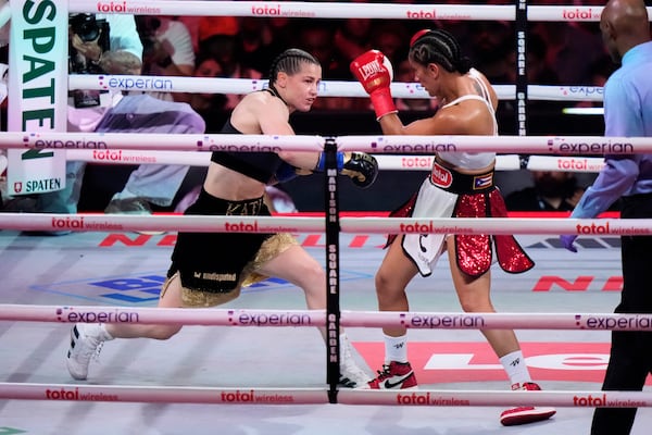 Ireland's Katie Taylor, left, punches Puerto Rico's Amanda Serrano during the first round of a super lightweight championship boxing match Friday, July 11, 2025, in New York. (AP Photo/Frank Franklin II)