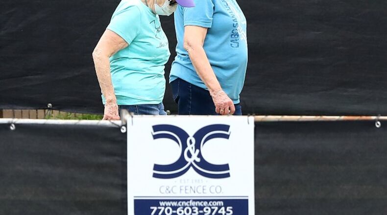March 12, 2020 Marietta: A pair of women behind a blackened fence where quarantined Grand Princess cruise ship passengers are isolated in a housing area at Dobbins Air Reserve Base on Thursday, March 12, 2020, in Marietta. Prior to arriving here, the passengers were medically screened by the U.S. Department of Health and Human Services and Centers for Disease Control and Prevention, said Col. Craig McPike, Dobbins installation commander. The passengers who were asymptomatic were transferred here and other federal military installations for COVID-19 testing and quarantine.” Should any individuals be identified as ill during their quarantine period, the Department of Health & Human Services, the lead federal agency, has procedures in place to transport them to a local civilian hospital. CDC is fully responsible for all aspects of the quarantine operation, and Dobbins personnel will have no contact with these passengers. By providing this support, Dobbins ARB is helping to protect the health of Americans by preventing the spread of the virus. Curtis Compton ccompton@ajc.com