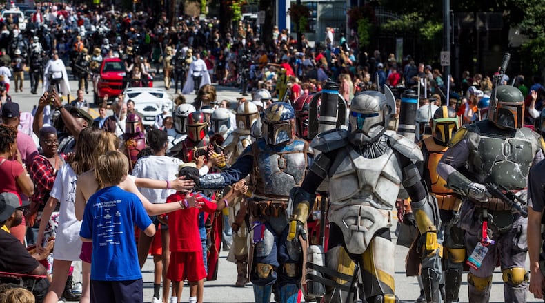 Large crowds gather along Peachtree Street Saturday to watch the Dragon Con parade in 2017. STEVE SCHAEFER / SPECIAL TO THE AJC