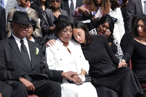 Marie Lourdes Love, center, and Maxum Love, left, attend the memorial service of their daughter, former U.S. Rep. Mia Love, with their granddaughters Abigale, center right, and Alessa, far right, at The Church of Jesus Christ of Latter-day Saints on the University of Utah campus in Salt Lake City, Monday, April 7, 2025. (AP Photo/Melissa Majchrzak)