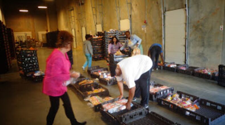 Volunteers help at the food pantry at Daily Bread for All. CONTRIBUTED