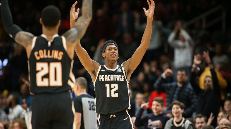 Atlanta Hawks forward De'Andre Hunter (12) celebrates with forward John Collins (20) after a made basket in the second half against the Los Angeles Clippers, Wednesday, Jan. 22, 2020, in Atlanta. The Hawks won 102-95. (AP Photo/Brett Davis)